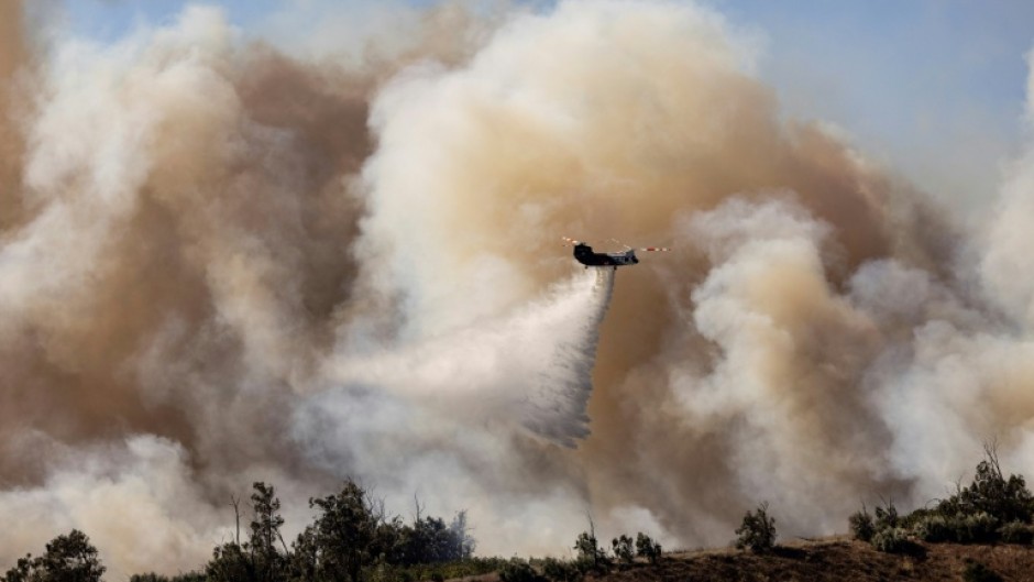 The Mountain Fire grew to burn over 20,000 acres (8,100 hectares) in the first two days, with towering flames leaping unpredictably and sending residents scrambling