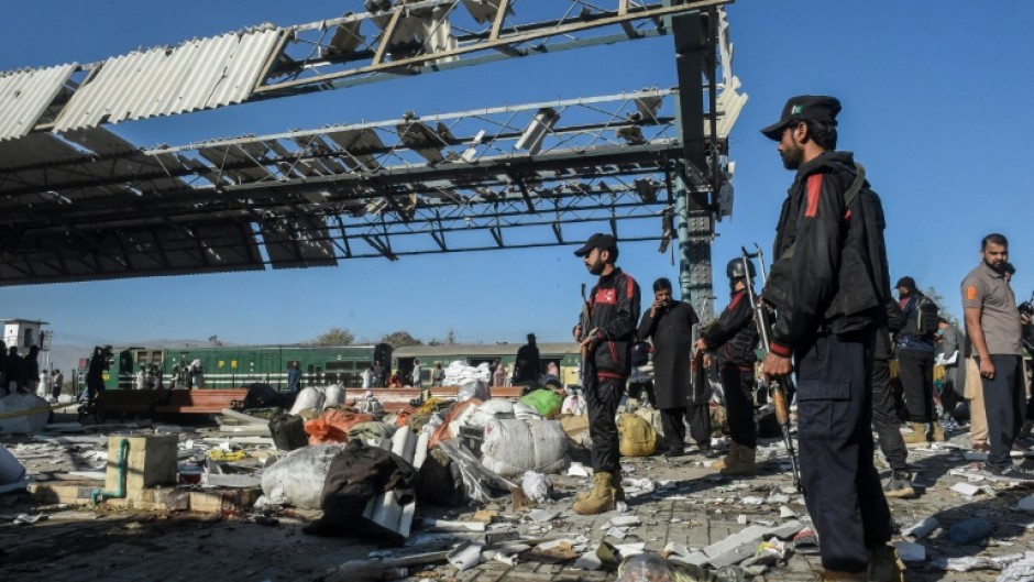 Firefighters, rescuers and passengers were working through abandoned luggage on the platform, guarded by heavily armed members of the security forces