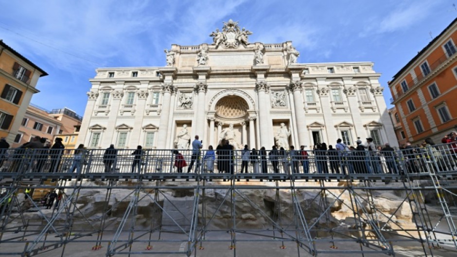 The fountain is being cleaned to remove limestone deposits and grime