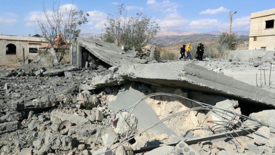 People check the damage a day after Israeli air strikes targeted the Lebanese village of Knaisseh near Baalbek in Lebanon's eastern Bekaa Valley