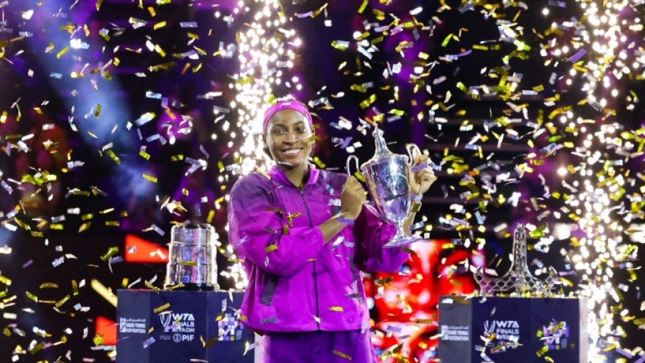 Coco Gauff poses with the trophy after defeating China's Zheng Qinwen to win the WTA Finals title