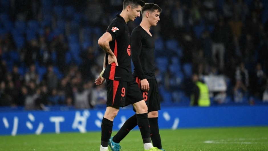 Barcelona's Robert Lewandowski (L) picked up a lower back injury in the La Liga defeat at Real Sociedad