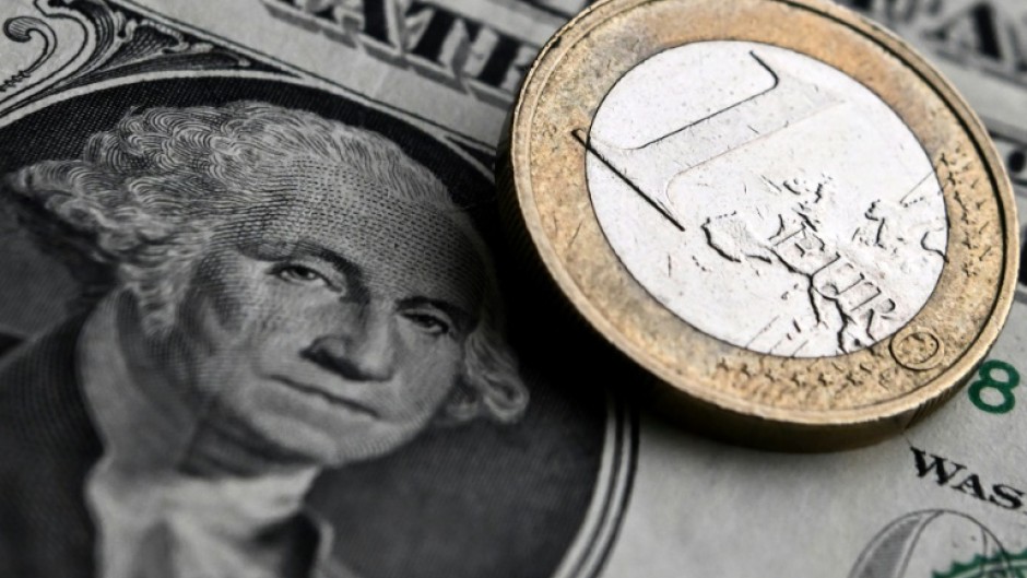 The euro hit a one-year dollar low on Tuesday, dropping below $1.06