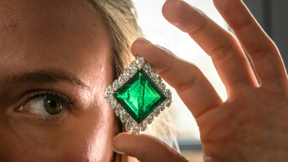 A Christie's employee poses with The Aga Khan Emerald