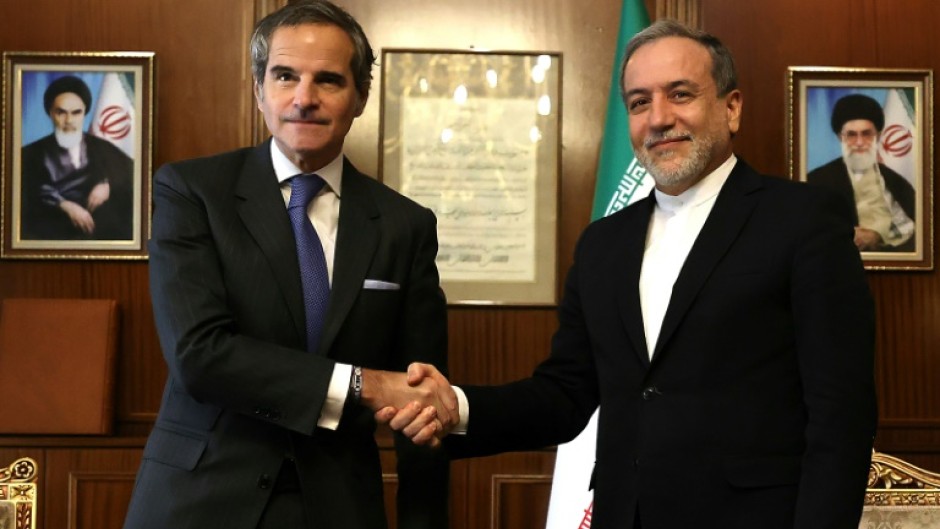 International Atomic Energy Agency chief Rafael Grossi (L) shakes hands with Iranian Foreign Minister Abbas Araghchi before their meeting in Tehran.