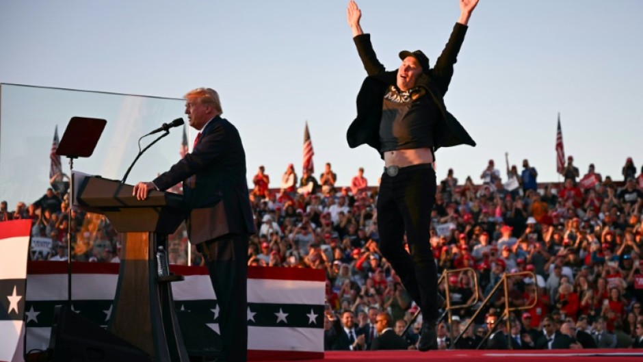 Tesla and SpaceX CEO Elon Musk exults during a Donald Trump rally in Pennsylvania in October 2024 -- the pair have become fast friends