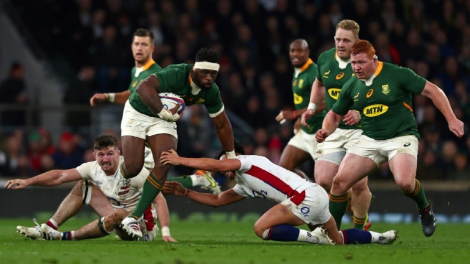 South Africa's Siya Kolisi avoids a tackle from England fly-half Marcus Smith at Twickenham in 2021