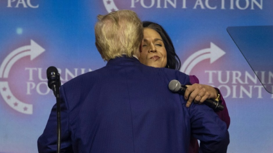 US President-elect Donald Trump embraces former US Representative Tulsi Gabbard, whom he has tapped for a top intelligence role 