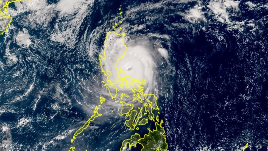 A Himawari satellite handout photo from the Japan Meteorological Agency website shows Super Typhoon Man-yi making landfall on the island of Luzon in the Philippines