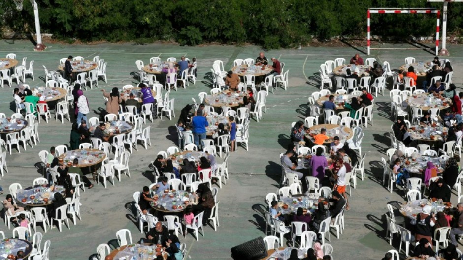 People have breakfast at school hosting displaced Lebanese in the southern city of Sidon