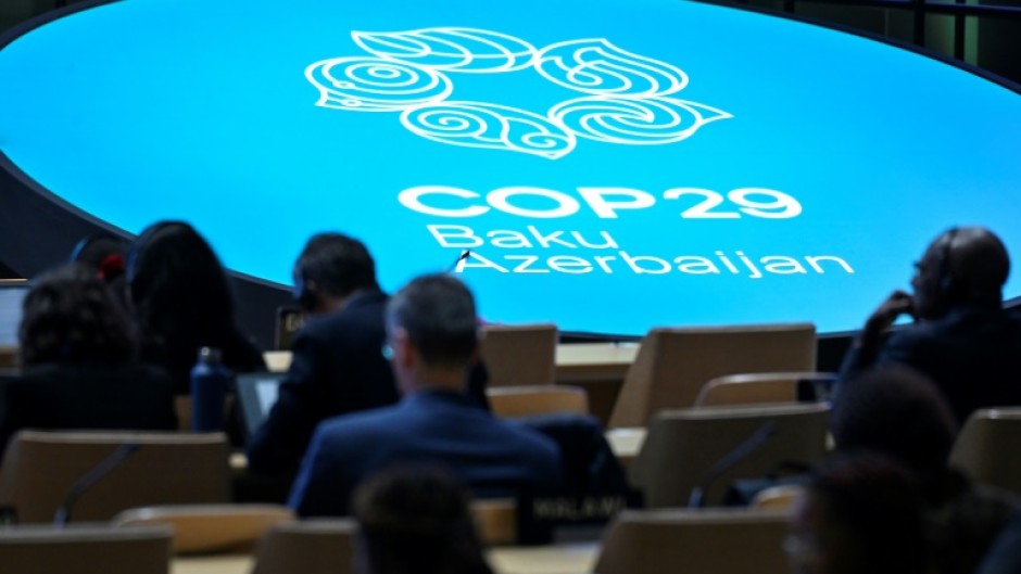 Delegates listen to speeches at COP29 in Baku