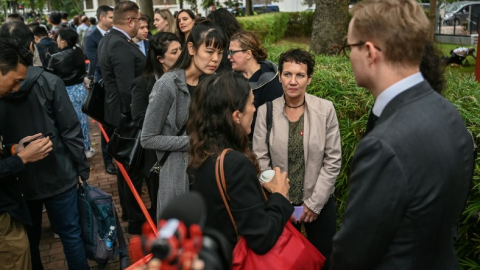 Diplomats queue outside the West Kowloon Magistrates' Court in Hong Kong 