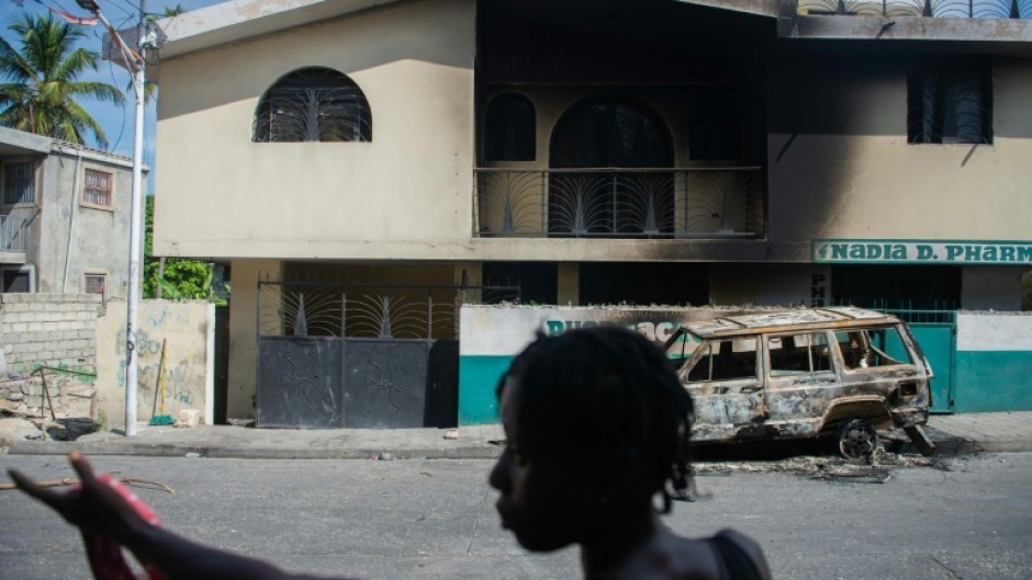 A woman looks at a damaged business in the Solino district of Port-au-Prince on November 16, 2024