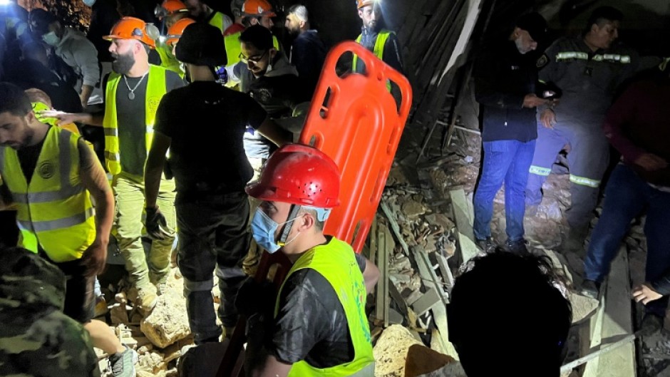 Members of the Lebanese emergency services works at the site of an Israeli strike that targeted Zuqaq al-Blat neighbourhood in Beirut