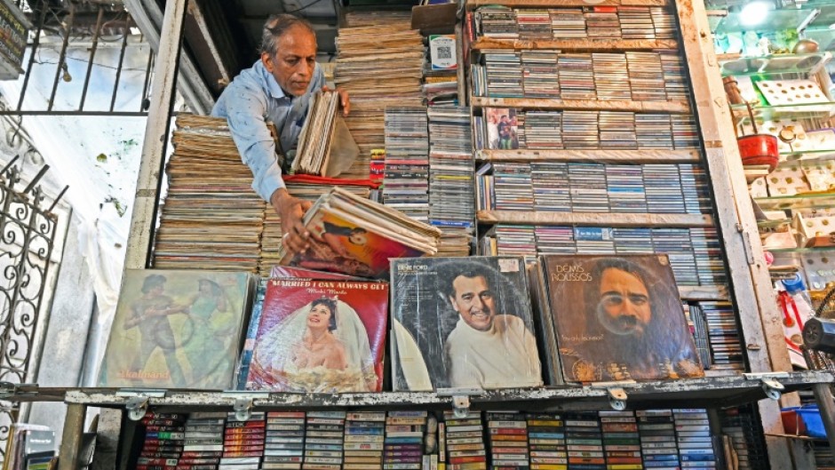 Royal Music Collection store owner Abdul Razzak arranges vinyl records at his shop in Mumbai