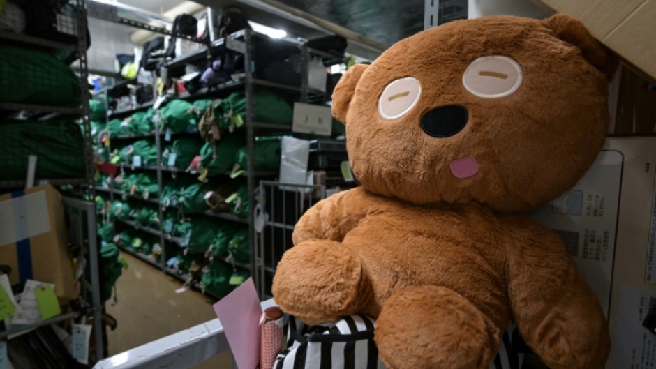 A teddy bear sits amongst thousands of items -- all bagged, tagged and organised based on where and when they were lost - at the Tokyo police department's lost and found centre