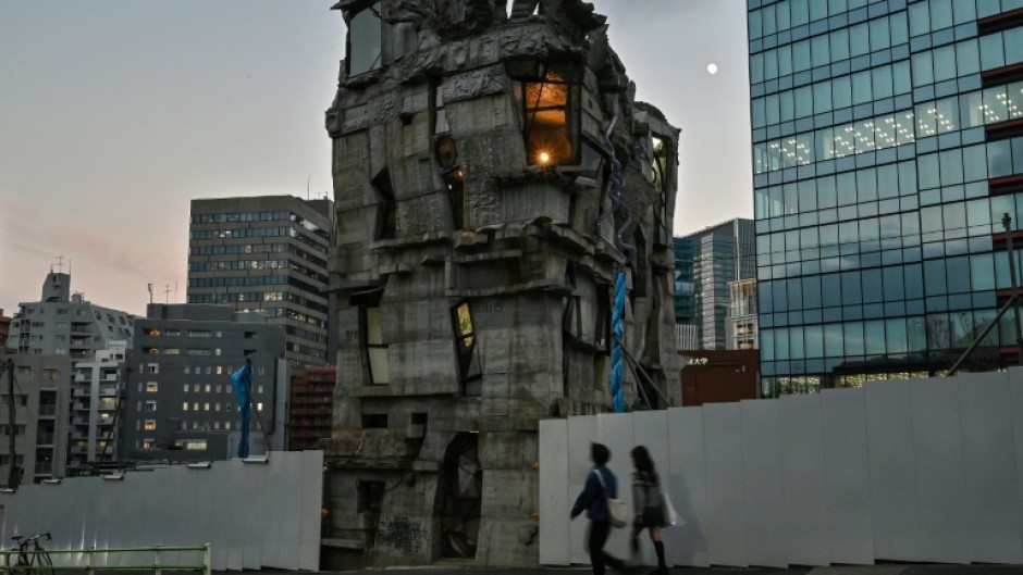 Pedestrians walk past the four-storey Arimaston Building created by Japanese architect Keisuke Oka in Tokyo