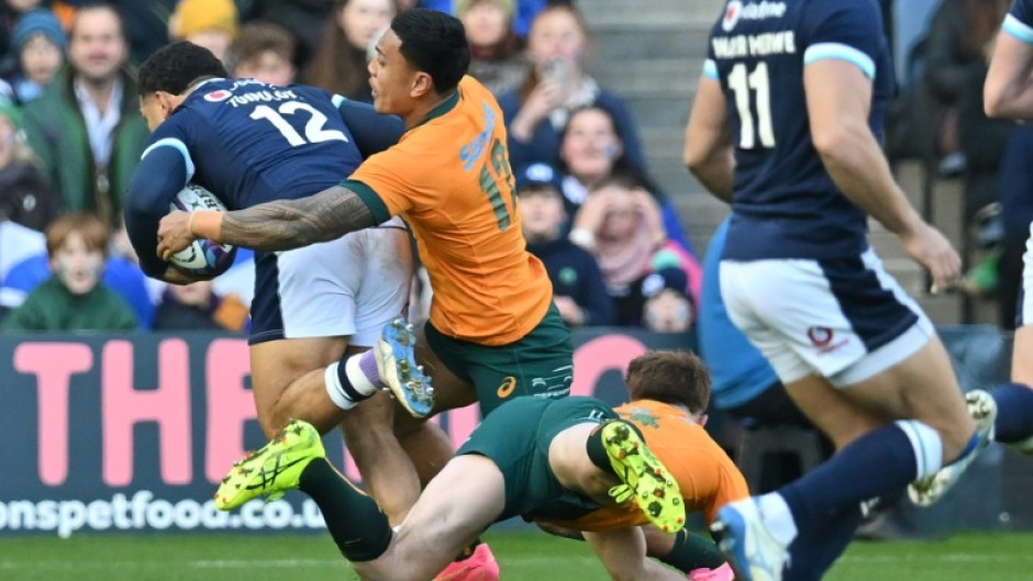 Key score: Scotland's captain Sione Tuipulotu (L) runs to the line to score the first try of a one-off Test against Australia at Murrayfield