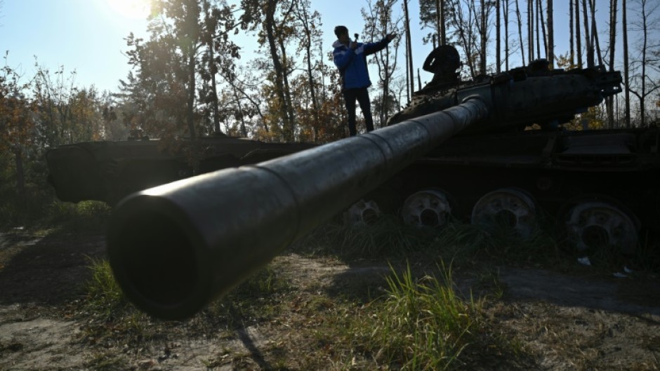 Spanish traveller Alberto Blasco Ventas visits a tank graveyard during a tour near Dmytrivka village outside Kyiv