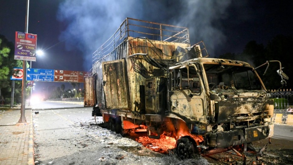 A rally truck used by Bushra Bibi, the wife of Pakistan's former prime minister Imran Khan, after being set ablaze in Islamabad at the height of the protests