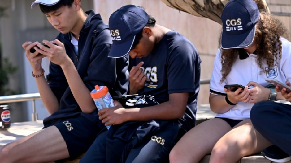 Students look at their phones in Australia, where the government has passed a law banning social media for those under 16