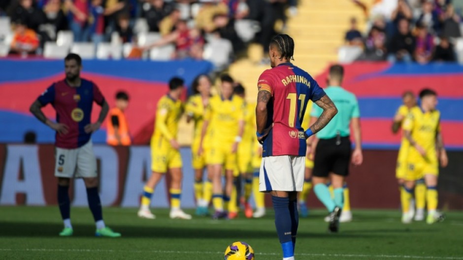 Barcelona's Brazilian forward Raphinha (R) reacts after Las Palmas scored their first goal