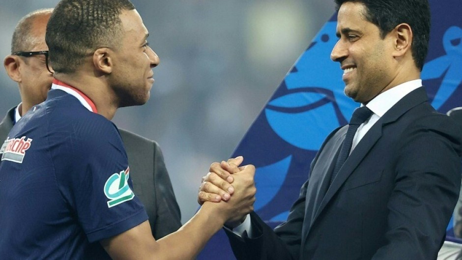 France star Kylian Mbappe (L) and Paris Saint-Germain president Nasser Al-Khelaïfi (R) after the team's French Cup final victory at Lyon on May 25, 2024