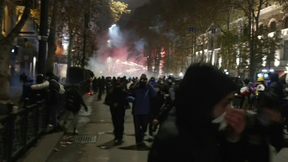 Protesters in Georgia shoot fireworks as riot police create barricade