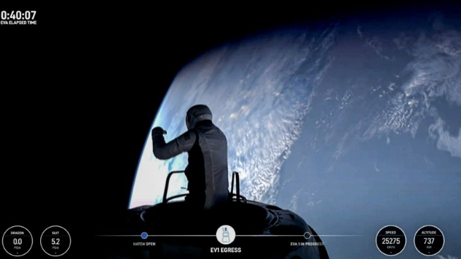 US fintech billionaire Jared Isaacman (EV1) peeks out to space from a hatch structure called "Skywalker," during the first private spacewalk performed by the crew of the SpaceX Polaris Dawn mission