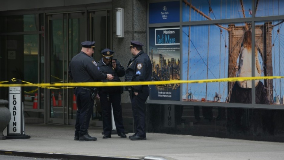 Outside the hotel senior police commanders briefed officers, as plainclothes detectives passed by upturned paper cups marking evidence