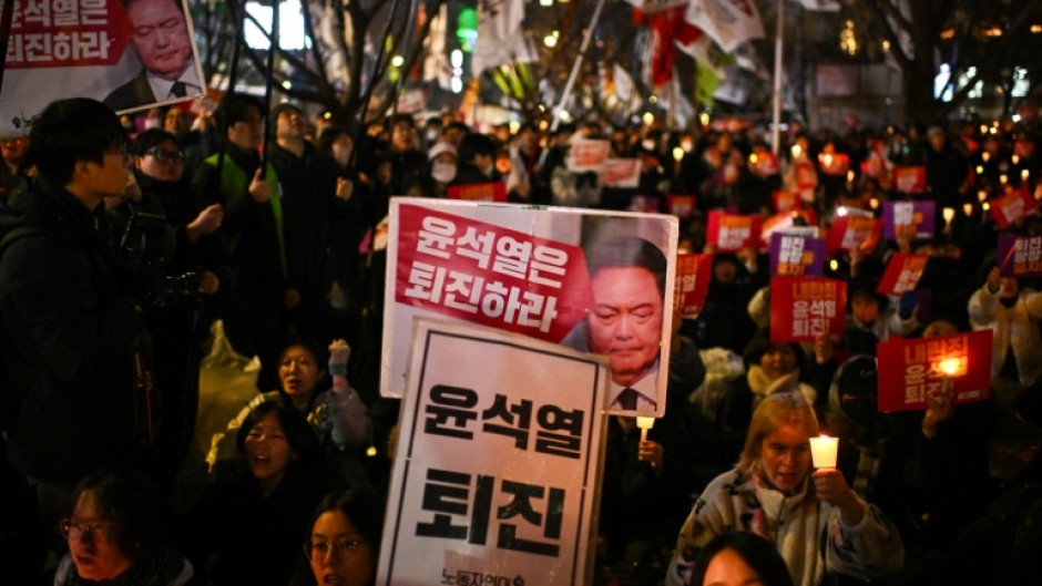 People take part in a candlelight vigil calling for the resignation of South Korean President Yoon Suk Yeol 