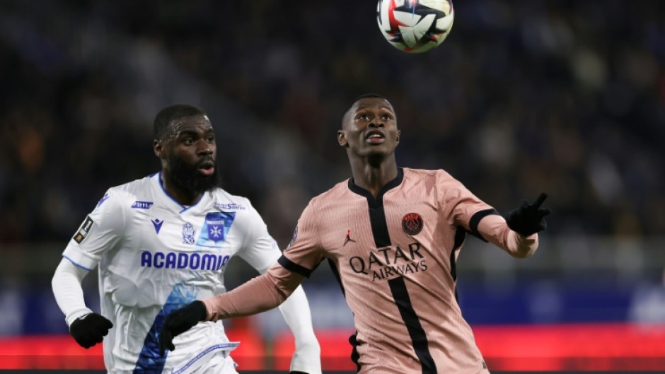 Paris Saint-Germain's Nuno Mendes (R) holds off Lassine Sinayoko of Auxerre during Friday's goalless draw in Ligue 1