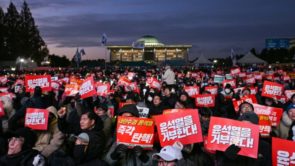 Protesters poured into the area around South Korea's National Assembly as lawmakers voted on a motion to impeach President Yoon Suk Yeol