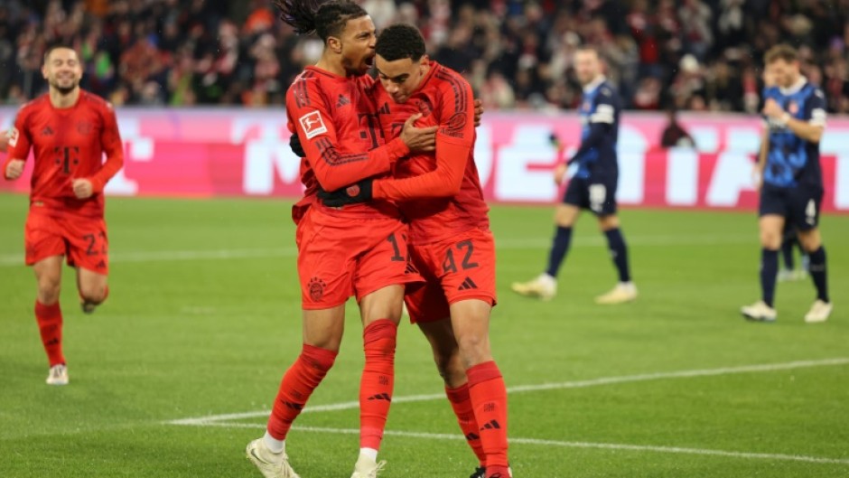 Bayern Munich forward Jamal Musiala (R) celebrates with Michael Olise