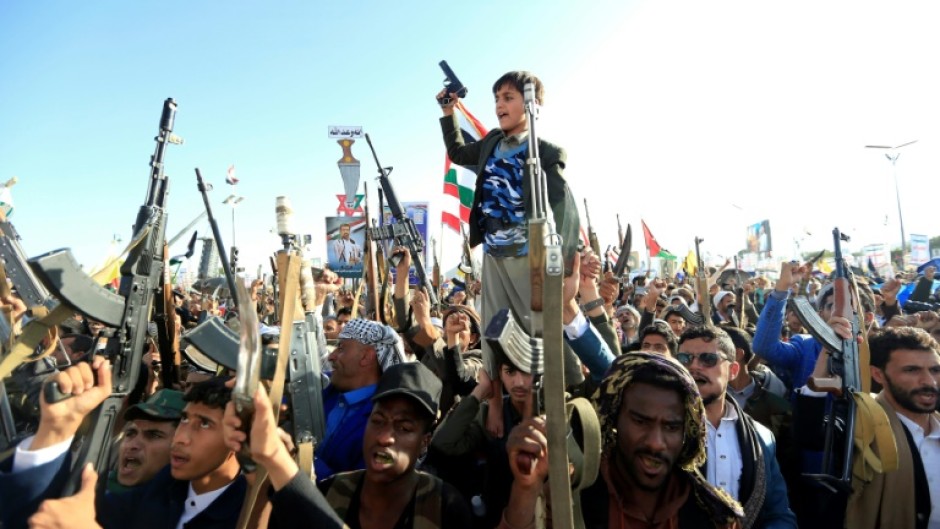 Yemenis brandish rifles and chant slogans during regular anti-Israel demonstrations in Sanaa