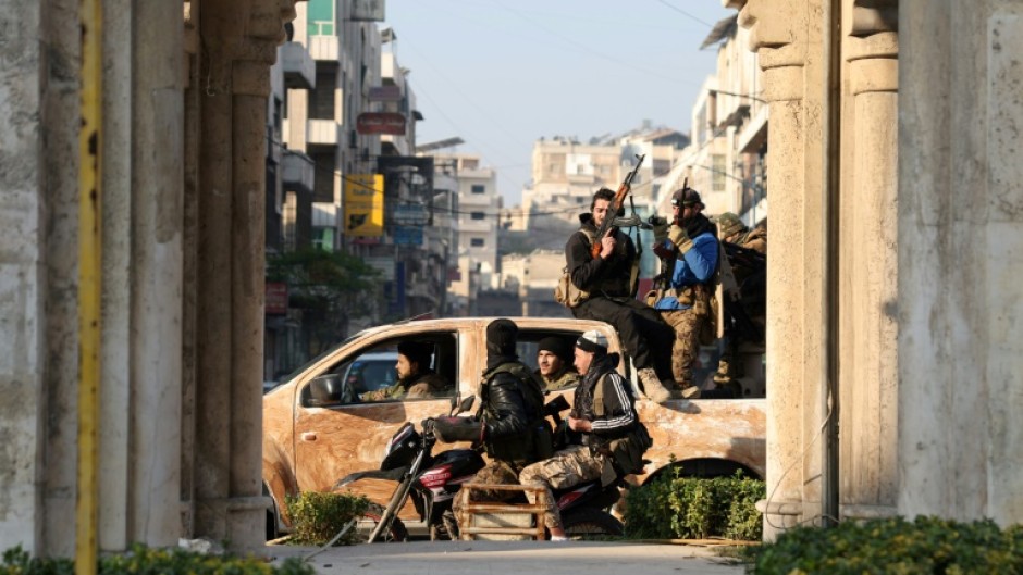 Rebel forces patrol the streets of Hama