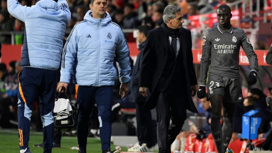 Real Madrid's French defender Ferland Mendy (R) leaves the pitch after an injury against Girona