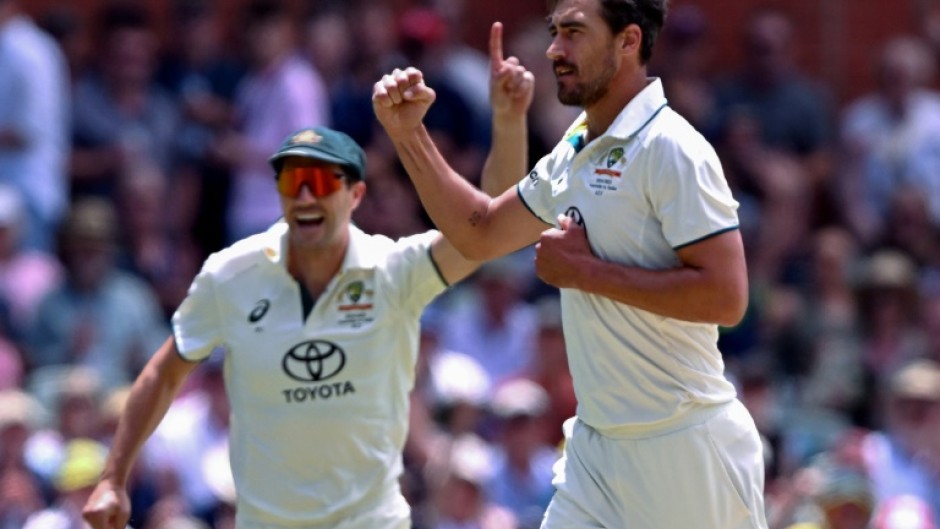 Australia's Mitchell Starc (R) and captain Pat Cummins celebrate another Indian wicket