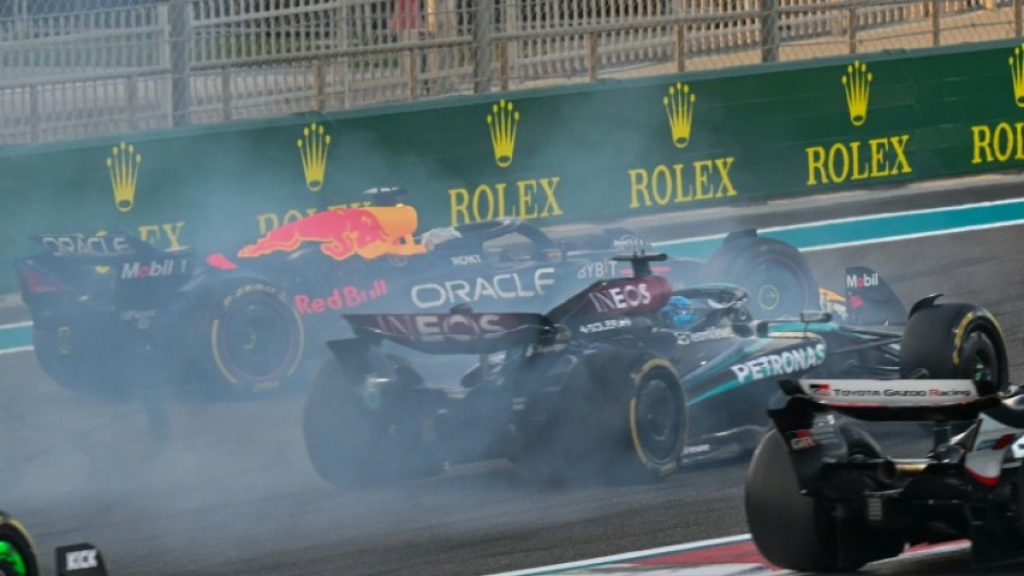 Red Bull's Max Verstappen (L) drives on after his collision with Oscar Piastri in Abu Dhabi