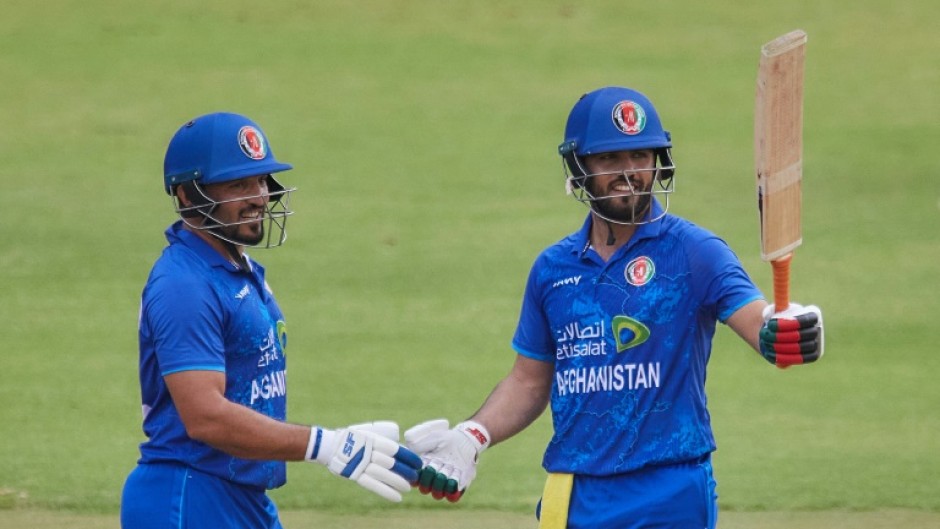 Darwish Rasooli (R) celebrates with Gulbadin Naib after scoring his first fifty for Afghanistan in a Twenty20 international against Zimbabwe in Harare on December 13.
