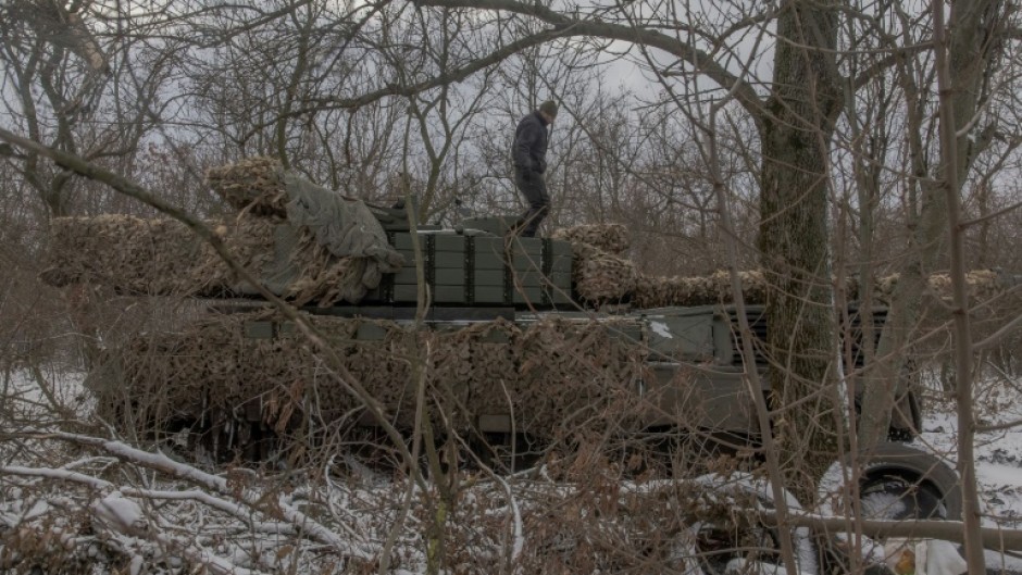 A Ukrainian tank crew member of the 68th Jaeger Brigade stands on a Leopard 1A5 tank near Pokrovsk