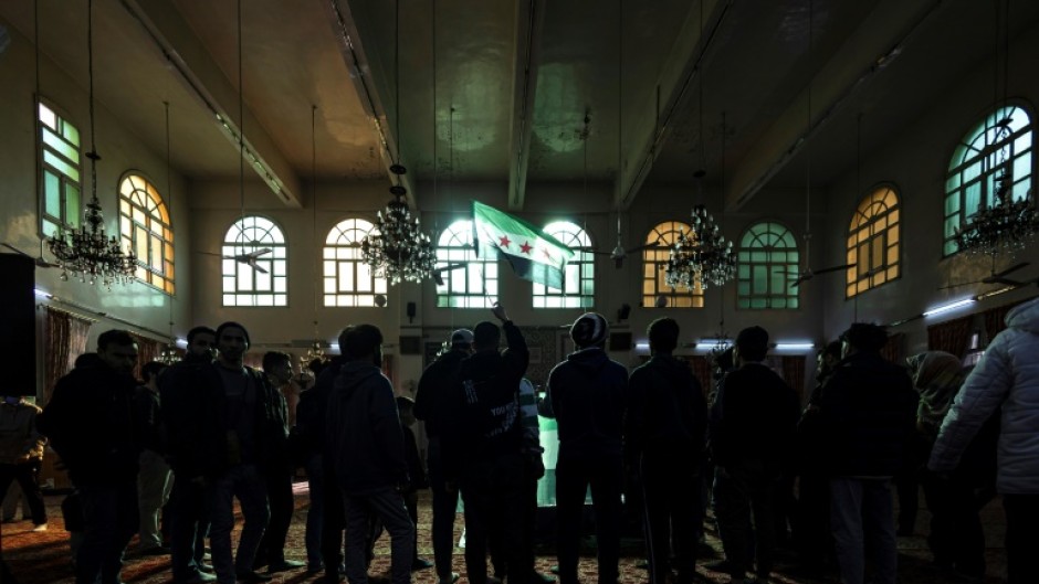 Mourners hold a funeral for Syrian activist Mazen al-Hamada