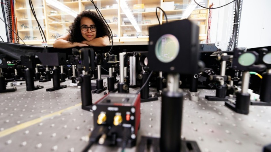 Experimental physicist Daniela Angulo poses with an apparatus in the physics lab at the University of Toronto