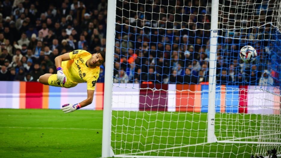 Marseille goalkeeper Geronimo Rulli watches Lille's leveller fly past him