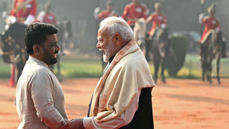 Sri Lanka's President Anura Kumara Dissanayake (L) speaks with India's Prime Minister Narendra Modi  