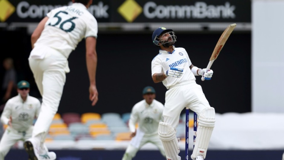 India's Virat Kohli (R) faces a bouncer from Australia's Mitchell Starc