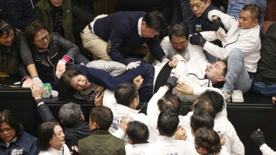 Taiwanese lawmakers tackled each other as President Lai Ching-te's party tried to block the passage of bills they say could harm the self-ruled island's 'democratic system'