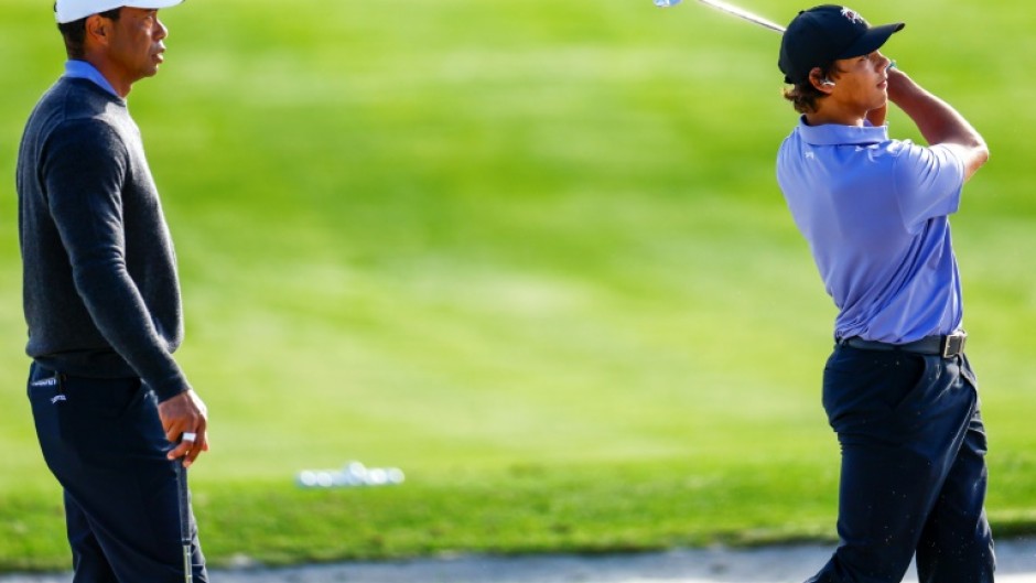 Tiger Woods, left, watches son Charlie practice ahead of the weekend's 36-hole PNC Championship for parent and child pairs