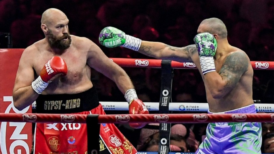 Ukraine's Oleksandr Usyk (blue trunks) gets the measure of Britain's Tyson Fury (red trunks) in Usyk's unanimous decision victory in their heavyweight world title fight at the Kingdom Arena in Riyadh