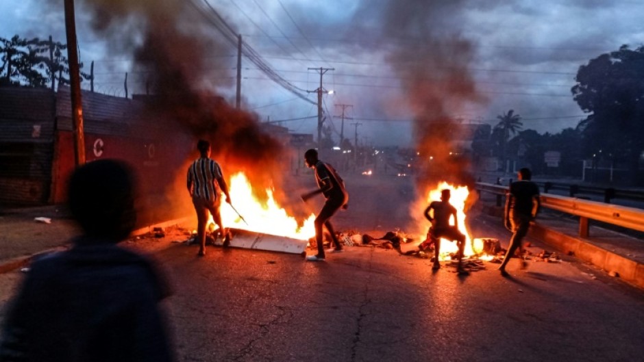 Protesters gathered next to a burning barricade in Maputo on Monday after the victory of the long-ruling Frelimo party was confirmed